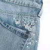 Blugi largi, cu talie joasă, cu spălare medie, cu fluture Blugi largi, cu talie joasă, cu spălare medie, cu fluture