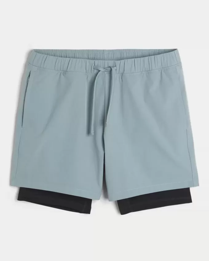 Pantaloni scurți activi hibridi la jumătatea coapsei Pantaloni scurți activi hibridi la jumătatea coapsei