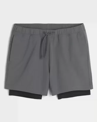 Pantaloni scurți activi hibridi la jumătatea coapsei