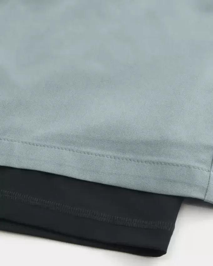 Pantaloni scurți activi hibridi la jumătatea coapsei Pantaloni scurți activi hibridi la jumătatea coapsei