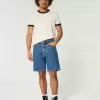 Pantaloni scurți de denim largi deasupra genunchiului Pantaloni scurți de denim largi deasupra genunchiului
